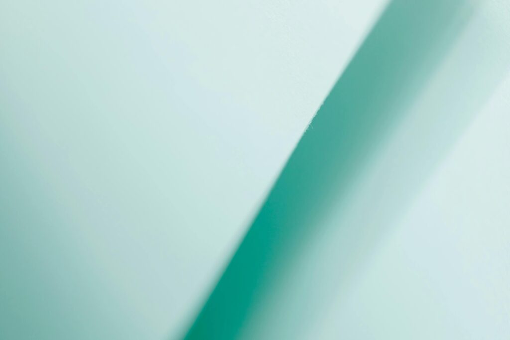 Abstract turquoise gradient background featuring a diagonal line, perfect for modern design projects.